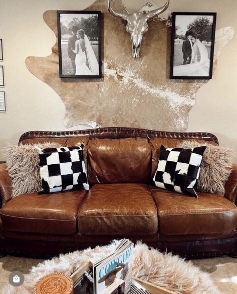 Cowhide Rug On Wall Master Bedrooms, Cowhide Above Bed, Western Photo Wall Collage Living Room, Cow Hyde Living Room Decor, Western Sitting Room Ideas, Western Grunge Living Room, Edgy Western Home Decor, Double Wide Trailer Living Room Ideas, Cowboy Chic Decor Living Room