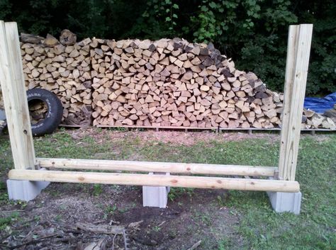 No tool firewood rack. Just some cinder blocks, 2x4s, and fence rails. Firewood Holders, Firewood Storage Outdoor, Wood Sheds, Outdoor Firewood Rack, Firewood Racks, Wood Storage Rack, Landscape Timbers, Lake Ideas, Firewood Shed