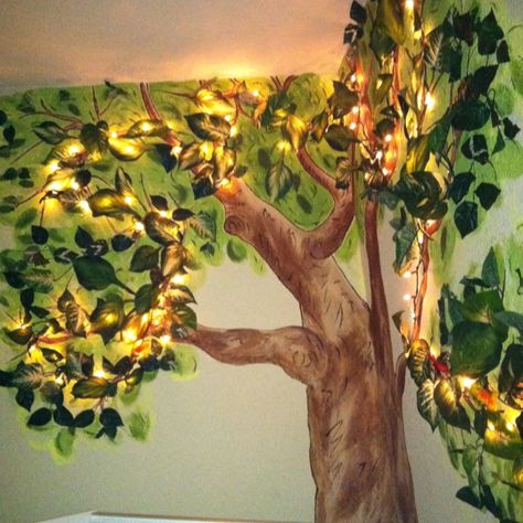 Connor's nightlight tree: in his nursery I painted a tree, then strung mini lights with brown wire (meant for a wooden rustic wreath), then stapled multiple sized silk leaves for a 3D effect and a green glow. Nursery With Tree Mural, Forest Wall Mural Painted Bedroom, Tree Murals On Wall Diy, Zelda Themed Nursery, Woodland Mural, Diy Moss, Forest Room, Sustainable Flowers, Tree Mural