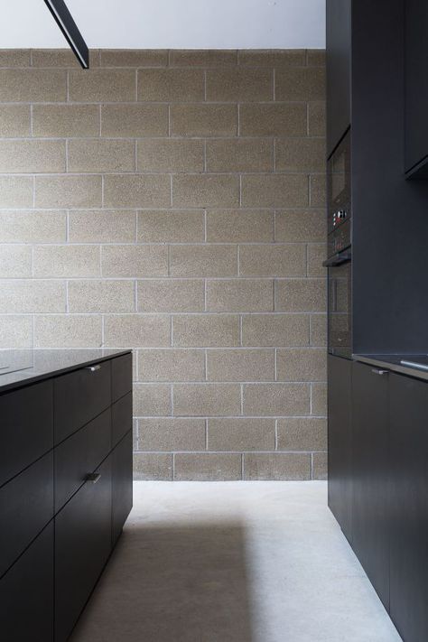 Industrial materials were exposed and celebrated in this home with black MDF for the kitchen, concrete and exposed blockwork. Cinder Block House, Concrete Block House, Masonry Blocks, Breeze Block Wall, Wall Decorating Ideas, Mdf Wall Panels, Concrete Block Walls, Block House, Cinder Block Walls