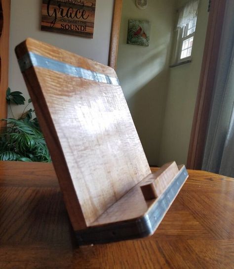 Awhile back I saw a really cool reclaimed wood cookbook/tablet stand advertised in a catalog. But the $110 price tag was a big "no, thanks" for me. Here is a tutorial on my version with plenty of options for you to customize a couple of your own.All of the materials used were on hand, so there was no cost involved other than an afternoon of our time. In the complete blog, I offer tons of suggestions for alternate materials, trim and finishes. Check it out! Cookbook Stand Diy, Diy Tablet Stand, Diy Recipe Book, Recipe Book Stand, Recipe Book Holders, Diy Cookbook, Water Based Wood Stain, Salvaged Furniture, Cookbook Holder