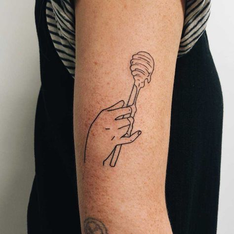 A tattoo of a hand holding a honey dipper tattoo on the right arm Tattoo Of A Hand, Honey Pot Tattoo, Dipper Tattoo, Pot Tattoo, Honey Tattoo, Related Tattoos, Cage Tattoos, Belly Tattoos, Harry Styles Tattoos