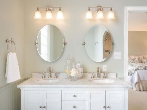 Bathroom Double Vanity Mirrors And Lights, Bathroom Vanity Lighting Ideas Double Sinks, Oval Bathroom Mirrors Double Vanity, Bathroom Vanity Lighting Over Oval Mirror, Double Vanity Mirror Ideas, Rustic Bathroom Light Fixtures, Charming Bathroom, Bathroom Lights Over Mirror, Rustic Bathroom Lighting