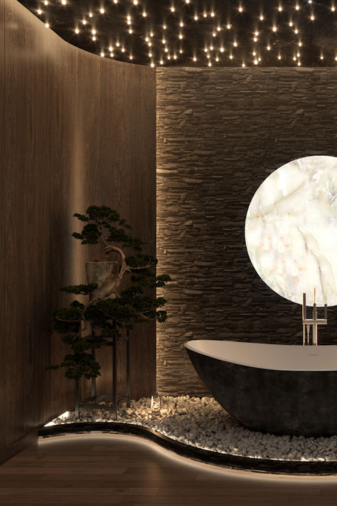 A luxury spa bathroom featuring a black stone freestanding tub on white pebbles, glowing onyx moon wall art, starry ceiling lights, wood paneling, and a bonsai tree. Stone Accent Wall, Starry Ceiling, Luxury Spa Bathroom, Commercial Space Design, Stone Tub, Stone Accent Walls, Spa Bathroom, Online Interior Design Services, White Pebbles