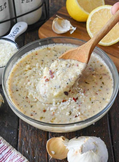 Using a wooden spoon to stir a bowl of garlic parmesan sauce. Wild Wings Garlic Parmesan Sauce, Copycat Buffalo Wild Wings, Wings Garlic Parmesan, Parmesan Wing Sauce, Garlic Wings, Parmesan Wings, Garlic Parmesan Wings, Wing Sauce Recipes, Garlic Sauce Recipe