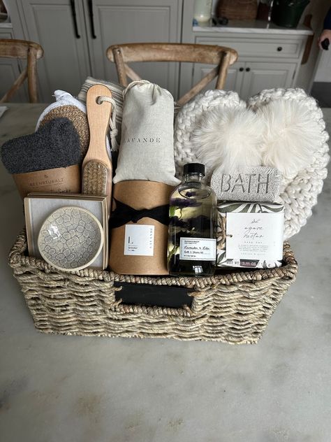 Luxury spa gift basket! Do you know someone who could use a little downtime? Check out our beautiful luxury, spa gift basket filled with products to help you relax and unwind! Reusable woven storage basket contains lightweight Cotton throw blanket by Creative Woman , Lemo'n crocheted ballerina slippers with fur pom-pom and Sherpa lining ( one size fits all) Oh so cozy lavender and lilac bath and shower gel, agave and nectar Soap  bar, BATH pumice  stone, wooden nail brush, exfoliating bath pad, super cozy socks, large lavender sachet, 7 ounce heavenly scented lavender soy candle and beautiful handmade pottery trinket dish to store y trinkets and treasures.  Why give a perishable gift when you could give a gift basket fill with items for the recipient to use.  Include a gift message upon or Relaxation Gift Basket, Spa Kits, Luxury Gift Basket, Creative Gift Baskets, Spa Basket, Care Basket, Healing Journaling, Spa Gift Set, Gift Baskets For Women