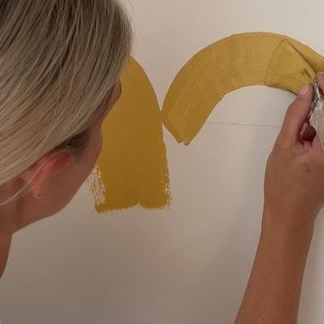 Lick on Instagram: "Transforming this cold, empty room into a warm and cosy nursery because…Tash is having a baby! *excited eeek* This is how she created a joyful colour scheme that can be enjoyed at all times of the day, and night, including a DIY scalloped half-wall in Tash’s favourite colour, yellow, and adding blue accents. How Tash created this joyful scheme: 🎨 Warm White 03 was used as the base colour to add a soothing feel to the whole space and balance the cooler natural light. 🎨 A half-wall scallop design was then painted using a kitchen bowl (decorating hack), in optimistic ochre Yellow 02 to give the space a playful feel, without overwhelming the room. 🎨 To finish, blue accents were added, including a Blue 15 upcycled chest of drawers, to complement the yellow and nod to the Scalloped Half Wall, Yellow Scalloped Wall, Cosy Nursery, Upcycled Chest Of Drawers, Kitchen Bowl, Times Of The Day, Scallop Design, Ochre Yellow, Kitchen Bowls