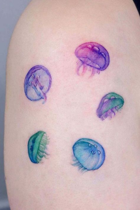 Discover the art of transformation with jellyfish tattoos in our article. Explore it and find 50+ stylish designs with meanings explained. Cute Jellyfish Tattoo, Jellyfish Tattoo Color, Jelly Fish Tattoos, Color Tatoos, Watercolor Jellyfish Tattoo, Moon Jellyfish Tattoo, Tattoo Ideas Colorful, Watercolor Tattoo Design, Purple Tattoo