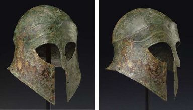 A GREEK BRONZE CORINTHIAN HELMET ARCHAIC PERIOD, CIRCA EARLY 6TH CENTURY B.C. Hammered from a single heavy sheet, the flaring neck-guard notched at the sides, the cheek-pieces tapering to points, the almond-shaped eye holes and long projecting nose-guard finely contoured, the perimeter with incised detailing, the high-arching eyebrows mirrored above and extending into carination encircling the crown, the cheek-pieces and the perimeter near the notches perforated for the attachment of a lining, Arching Eyebrows, Greek Armour, Material Reference, Greek Helmet, Corinthian Helmet, Ancient Armor, Historical Armor, Knight Armor, Arm Armor