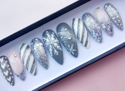 Silver Glitter, Grey and light Pink Handpainted False nails set on long stiletto shape. * Available in any shape & length. * Available in set of 10 nails and full set of 20 nails. All nail sets are handpainted, made with high quality salon products and genuine crystals. Some of nail sets have handpainted drawings. * Each order set includes nail prepare kit - mini nail file , storage gift box with a ribbon. If you have any questions feel free to send me a message. ^^ Disclaimer. * Actual colors m Snowflakes Nail Art, Sweater Nails Christmas, Frost Nails, Gray Winter Nails, Gray Christmas Nails, Glitter Snowflake Nails, Christmas Nail Set, Snowflake Nails Silver Glitter, Dark Christmas Nails