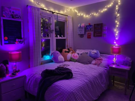 a white bed against a window with christmas lights, pink led lights, and multiple art pieces Bedroom Ideas Squishmallows, Squishmallows Aesthetic Bed, Squishmallows On Bed Aesthetic, Alt Girl Bedroom, Alt Girl Room, Big Room Aesthetic, Alt Bedroom Aesthetic, Squishmallows Bedroom, Big Bedroom Aesthetic