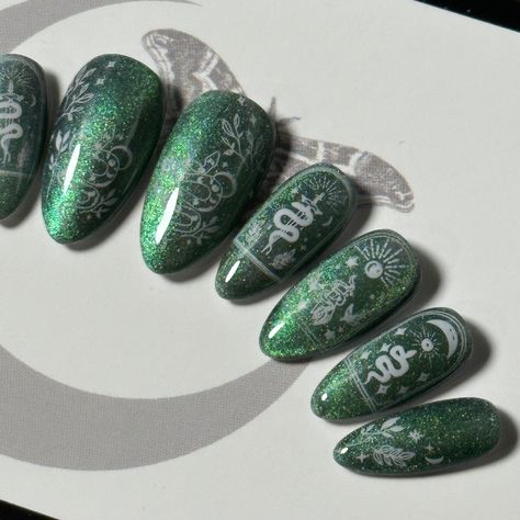 Welcome to LD Nails! 🖤 One set of 10 REUSABLE Press On Nails 🖤 🖤 Made to order in your shape & size 🖤 🐍 Stellar Snake: green cat eye witchy press on nails with white celestial snake detailing. Purchase INCLUDES an application kit! It consists of: 🖤 detailed application & removal instructions 🖤 a sealed and sanitary mani kit (100/180 file, buffer block, cuticle pusher) 🖤 2 alcohol pads 🖤 nail tabs or glue (glue is standard, request tabs in the personalization box if you prefer them!) *Only one kit is sent per order. Extra kits and kit contents can be picked up here 👉 https://www.etsy.com/ca/listing/817160463/application-kit-press-on-nails-gothic Est. 2020: LD Nails specializes in custom Gothic, Witchy and Alternative Press On Nails. I draw inspiration from what I love, so you’ll f Dark Green Aesthetic Nails, Slytherin Nails, Celestial Snake, Nails Gothic, Snake Green, Green Cat Eye, Nails With White, Birthday Nail Designs, Birthday Nail