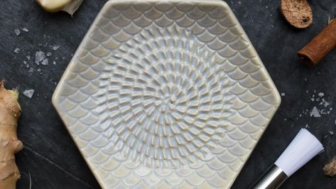 Introducing, your new go to essential kitchen tool: Grate Plate! The Handmade Ceramic Grating Plate used to grate Garlic, Ginger, Nutmeg, Hard Cheese and so much more. The set includes a silicone garlic peeler and wooden handle gathering brush! . . . #grateplates #kitchenessentials #kitchentool #kitchenwares #kitchenaccessories #grater #foodiegift #foodielife #letscook #kitchenshop #burnstn #fairviewtn #franklintn #brentwood #shoplocalnashville #mossandemberstn #mossandembers Ceramic Grater, Ginger Grater, Garlic Peeler, Garlic Grater, Bread Dip, Plate Ceramic, Essential Kitchen Tools, Garlic Clove, Kitchen Shop