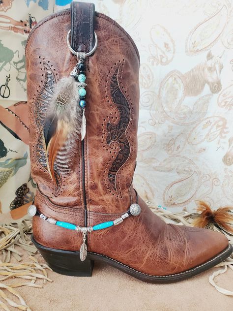 "Western Cowboy Boot Bling, Boot Topper made with real feathers, beads and a silver colored metal feather. Handmade by me in the U.S. by me. Listing is for one feather Boot Topper - Boot Bracelet sold separately. Metal ring is 1.25\" in diameter. I have other Boot Bling Toppers and Boot Bracelets: https://www.etsy.com/shop/BlueEyesDesignsHB?ref=simple-shop-header-name&listing_id=921398039&section_id=36661297 I can make matching choker, Cowboy Western Hatbands, bracelet, necklace and more. Thanks Boot Bling Diy, Cowboy Boot Jewelry, Boot Jewelry Diy Ideas, Indian Boots, Cowboy Boot Crafts, Neon Cowboy, Cowboy Spurs, Boot Charms, Cowboy Hat Bands