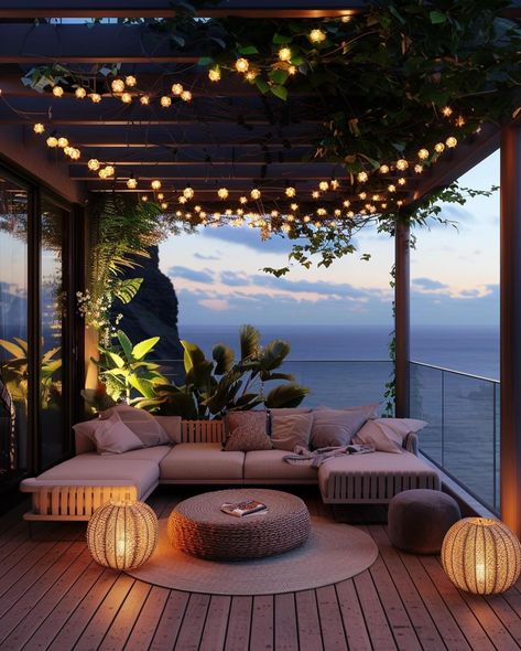 This pin depicts a beautifully designed outdoor lounge area at twilight. The space features a large, L-shaped sectional sofa with soft beige cushions.Hanging above the lounge area are strings of small, warm, globe-shaped fairy lightstwo spherical lanterns with a wicker design emit a warm light, adding to the inviting ambiance. Large Balcony Ideas House, Large Balcony Ideas Terraces, Balcony Fairy Lights, Large Balcony Ideas, Dream Balcony, Apartment Views, Balcony Oasis, Nature Lights, Aesthetic Peaceful