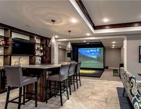 Golf Basement Man Cave, Golf Simulator Room With Bar, Garage Gym And Golf Simulator, Basement With Golf Simulator, Man Cave Golf Simulator, Golf Simulator Man Cave, Indoor Golf Simulator Man Cave, Basement Golf Simulator Room, Tv Room With Bar