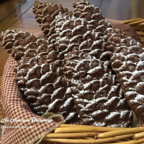 A wicker basket with chocolate cookies shaped like pinecones and dusted with powdered sugar to look like snow. Pinecone Cookie, Cookie Mold Recipes, Chocolate Almond Pinecones, Wood Cookie Mold Recipes, Shortbread Cookies In A Mold, Windmill Cookies Recipe, Wood Cookie Molds, How To Use Wooden Cookie Molds, Wooden Cookie Mold Recipes