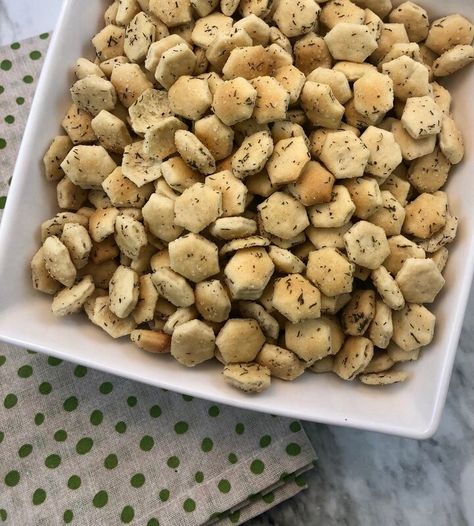 Are you a big fan of dill pickles? These Dill Pickle Oyster Crackers have a yummy buttery dill flavor. They are one of our favorite snack crackers for game or movie night. Do you know anyone who has such a dislike of a certain food that they can’t eat the food if that particular food has been near their food or on it? It’s funny to me. One of our family members completely despises pickles (The rest of us like them so much we bottle our own). Anytime he orders a burger and the fast food… Dill Crackers, Oyster Cracker Snack, Oyster Crackers Recipe, Pickle Seasoning, Seasoned Crackers, Flavored Nuts, Snack Crackers, Dill Pickle Recipe, Oyster Crackers