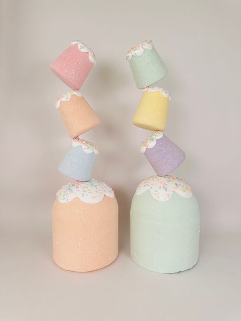 These delightful, jumbo sized fake gumdrops are perfect for adding a whimsical touch to any space. These oversized gumdrops are crafted from quality materials including foam clay. They come in an array of soft pastel colors, including pink, lavender, mint green, light blue, peach and yellow. Each gumdrop is topped with a playful dollop of faux frosting, colorful sprinkles, and a glittery cherry on top, making them look irresistibly charming.  These jumbo gumdrops are versatile decorative pieces. You can display them as standalone decorations on shelves or tables, incorporate them into festive centerpieces, for a magical holiday display. Lightweight yet sturdy, they offer a delightful and calorie-free way to add a touch of sweetness to your decor. Custom colors are also available upon reque Winter Candyland Decorations, Gumdrop Mountain Decorations, Candy Party Decorations Diy, Fake Marshmallows Diy, Giant Gumdrops Diy, Gumdrop Decorations, Giant Candy Decorations Diy, Candy Christmas Decorations Diy, Gumdrop Mountain