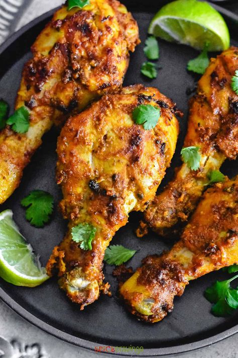 An easy tandoori chicken recipe with chicken marinated in an authentic yogurt-spice blend and baked or grilled until juicy and crisp. #tandoorichicken Indian Drumstick Recipes, Indian Chicken Wings, Tandori Spice Chicken, Indian Chicken Marinade, Easy Tandoori Chicken Recipe, Air Fryer Tandoori Chicken, Tandoori Chicken In Oven, Chicken Tandoori Masala, Chicken Drumstick Recipes Oven