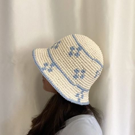 "Elevate your style with our charming handmade bucket hat featuring a delicate blue and white flower motif. Crafted from soft cotton, this unique hat boasts a trendy design perfect for adding a touch of whimsy to any outfit.". #crochet #hat #patterns #yarn #knitting Bucket Hat Crochet Design, Flower Bucket Hat Crochet Pattern, Blue Bucket Hat Crochet, Flower Bucket Hat Crochet, White Flower Crochet, Blue Crochet Hat, White And Blue Crochet, Bucket Crochet, Blue And White Crochet