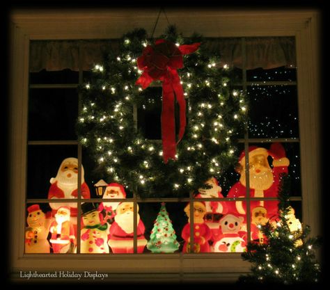 Small vintage Christmas blowmolds displayed in front window. Blow Mold Display, Santa Window Display, Blow Mold Christmas Display, Christmas Blow Molds Display, Vintage Christmas Outdoor Decorations, Vintage Christmas Window Display, Kitschy Christmas Decor, Store Front Christmas Window Display, Blowmold Christmas