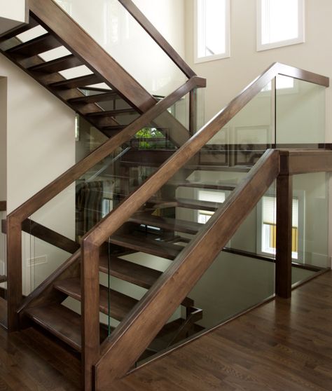 We designed an open rise maple stair with dadoed glass panel railing. The stair also incorporates a floor to ceiling glass wall to reinforce an unobstructed view. Stairs With Glass Panels, Wooden Staircase Railing, Custom Stairs, Interior Stair Railing, Glass Stairs, Stair Railing Design, Staircase Remodel, Open Staircase, Glass Staircase