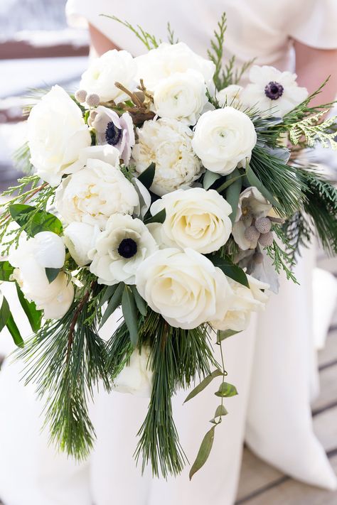 White rose, anemone, ranunculus, peony, brunia, pine, christmas greens bridal bouquet Greens Bridal Bouquet, Winter Wedding Flowers Bouquets, Pinecone Wedding, Anemone Bridal Bouquet, White Bridal Flowers, Winter Bridal Bouquets, White Peonies Bouquet, Christmas Greens, Simple Wedding Bouquets