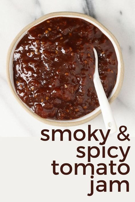 Smoky, Spicy, Tangy and just a little bit sweet, this Tomao Jam will be your favorite accompaniment to many things...your next cheese and cracker board, your next pizza, your next sandwich, and so many more. Recipe and instructions to water bath can. https://nourishandnestle.com/smoky-spiced-tomato-jam-recipe/ Spicy Tomato Jam Recipe Canning, Smoked Tomato Jam, Tomato Chilli Jam Recipe, Tomato Jalapeno Jam, Cowboy Tomato Jam, Tomato Relish Recipe Easy, Tomato Jam Recipes, Savory Tomato Jam, Spicy Tomato Jam