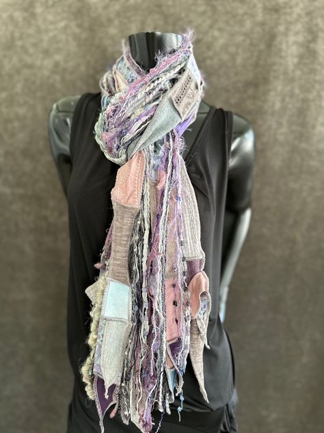 Lightweight handmade long artwear scarf in shades of lavendar, eggplant, peach, gray, cream, soft blues and coordinating shades. Artsy fiber fringe scarf, tribal scarf, boho accessory, tribal fashion. Perfect easy women gifts! **On person example is different colorblend. Pattern playtime! Shreds series Fringies! I’ve sold over 4,500 Fringies so I’m giving some a new “twist”. Multicolor fabric strips with sewn edges and ties plus glorious art yarn fringe. Approximately 6-9” long. This Shred series Fringie takes more time, as fabric needs to be sourced, cut, seamed, sewn, serged full edges. Two ties hold fibers together and are sewn to fibers. So simple, yet so fun and versatile! I have built up quite the stash of yarn, ribbon and random textiles over the years, that fringies are full of so Yarn Fringe, Style Scarf, Art Yarn, Boho Accessories, Fringe Scarf, Fabric Strips, Women Gifts, Yarn Art, Scarf Styles