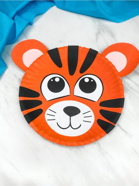 This paper plate tiger craft for kids is a simple project that's great for doing with preschool, pre k and kindergarten children. Download the free printable template and make for Letter T crafts or anytime! #simpleeverydaymom #animalcrafts #tigercrafts #paperplatecrafts #kidscrafts #preschool #kindergarten How To Make A Tiger Craft, T Is For Tiger Craft, Preschool Tiger Craft, Tiger Art Preschool, Tiger Art And Craft, Tiger Crafts For Toddlers, Tiger Arts And Crafts, Tiger Crafts For Preschool, Tiger Crafts For Kids