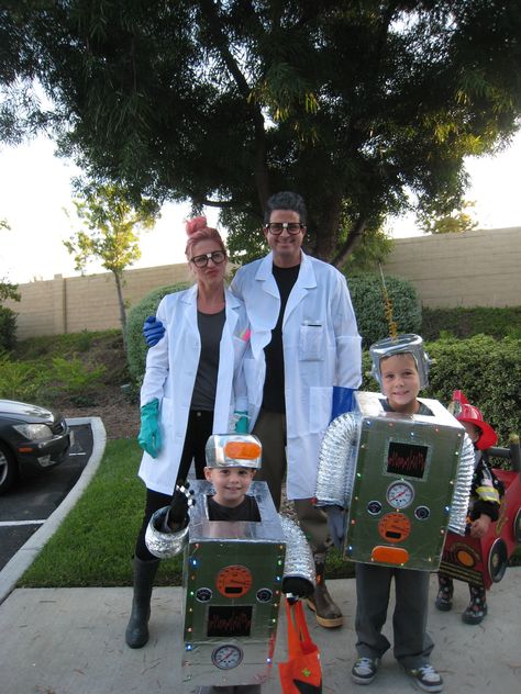 Mad Scientists and robot costume Scientist Family Costume, Mad Scientist Family Costume, Robot Costume Toddler, Diy Robot Costume Toddler, Robot Costume, Mad Scientist Costume Kids, Robot Costume Toddler Diy, Scary Scientist Costume, Robot Fancy Dress