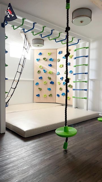 Diy Sensory Gym At Home, Basement Rock Wall, Rock Wall Basement, Indoor Kids Gym Playroom, Basement Sensory Gym, Things To Have In Your House, Diy Indoor Rock Wall For Kids, Fun Garage Ideas, Kids Gameroom Ideas