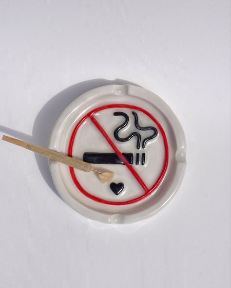 no smoking sign quirky ceramic ash tray, hand built, hand made and  hand painted in the UK. The ideal ashtray to complete your bad girl/ 420 stoner girl aesthetic. Also the perfect handmade gift for any stoner bestie. Find this functional art piece and more on sicalimited.com Functional Hand Built Pottery, Midnight Gospel Ashtray, Ceramic Art Ash Tray, Pottery Painting Ash Tray, Stone Clay Art, Clay Ashtray For Boyfriend, Y2k Ashtray, Clay Ash Trays Aesthetic, Hand Painted Ashtray