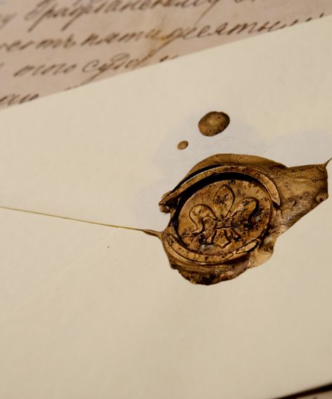 Vintage wax seal on cream envelope with cursive letter in background. Dark Envelope Aesthetic, Gold Envelope Aesthetic, Wax Sealed Letters Aesthetic, Royal Letter Aesthetic, Old Book Astethic, Wax Seal Aesthetic Dark, Letter Astethic Vintage, Letter Wax Seal Aesthetic, Sealed Letter Aesthetic