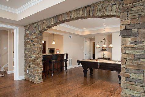 stone with arch...matches adjacent outdoor room... Stone Columns Interior, Interior Design Stone Wall, Stone Wall Bedroom, Accent Stone Wall, Stone Wall Accent, Living Room Stone Wall, Modern Stone Wall, Stone Wall Living Room, Stone Wall Interior