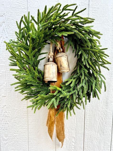 Real touch Norfolk Pine makes the most beautiful wreaths! I have several in my shop so be sure to check them all out! The one pictured has rustic gold bells and caramel-gold, velvet, distressed ribbon tails. A true eye catcher with beautiful Christmas curb appeal. You could even add a strand of micro lights to make it really pop!   All measurements are approximate  25"  * As with any wreath, some fading may occur over time if placed outdoors or in direct sunlight Please be sure to check your message/conversation notifications regularly until your order is received. I may have questions about specifics.  Thank you so much for shopping with me. I hope you've enjoyed your time at the Mercantile! Pine Christmas Wreath, Green Christmas Tree Decorations, Greenery Christmas, Outdoor Christmas Wreaths, Farmhouse Christmas Wreath, Wreath Greenery, Christmas Door Wreath, Decorated Wreaths, Norfolk Pine