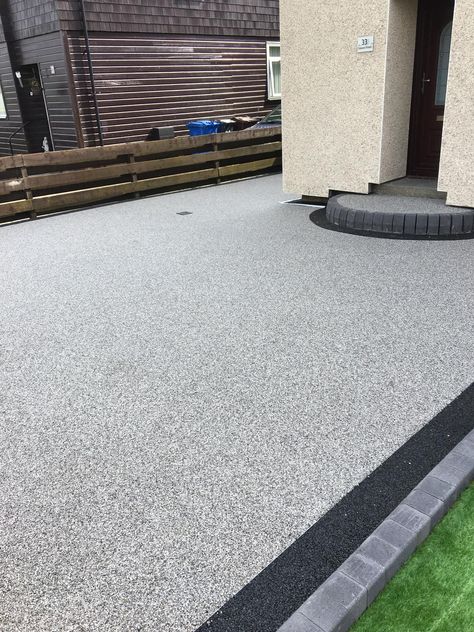 Titan Silver Resin Bound Aggregate Blend. A stunning alternative to loose gravel, block paving or tarmac this system is fully permeable, hardwearing and low maintenance. A highly versatile system, it can be applied easily to slopes, areas with limited access and intricate areas such as winding pathways.  From small patios to large sweeping driveways, resin bound surfacing is an ideal solution for any size project. CED Stone Inspiring Beautiful Landscapes Terrazo Driveway, Exposed Aggregate Patio Ideas, Low Maintenance Driveway, Resin Pathway Ideas, Resin Bound Patio, Resin Driveway Ideas, Front Garden Ideas Driveway, Garden Ideas Driveway, Resin Bound Driveways