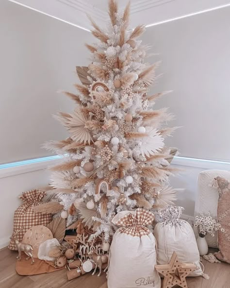 You Have to See These Flower Christmas Trees! White Christmas Tree With Pampas, Boho Theme Christmas Tree, Christmas Tree Pampas Decor, Boho Pink Christmas Tree, Boho Themed Christmas Tree, Christmas Theme Trees, Christmas Tree With Pampas Decor, Boho Christmas Tree Decorations, Pink Boho Christmas Tree