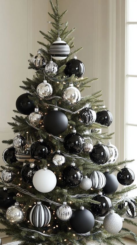 Black and white striped ornaments and glass baubles on a Christmas tree create an elegant winter wonderland theme. Christmas Tree Decorations Black White, Black And Silver Christmas Decor, Striped Ornaments, Striped Christmas Tree, White Holiday Decor, Black And White Christmas Decor, Black And White Christmas Tree, White Christmas Decor Ideas, Glam Christmas Tree