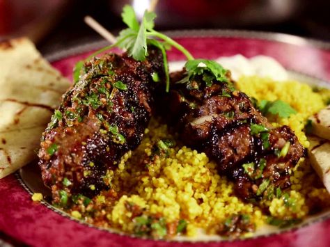 Get this all-star, easy-to-follow Moroccan Beef Kebabs with Curried Couscous, Raita and Charmoula Vinaigrette recipe from Diners, Drive-Ins and Dives Arabisk Mad, Curried Couscous, Moroccan Beef, Beef Kebabs, Beef Kabobs, Vinaigrette Recipe, Ras El Hanout, Vinaigrette Recipes, Moroccan Food