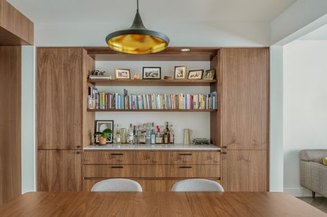 Custom walnut cabinets fill an entire wall of the dining room, proving enclosed storage, open shelving, and counter space. #customcabinets #walnutcabinets #custombuiltins #builtins #boardandvellum Built In Bar Buffet, Modern Dining Room Built Ins, Dining Room Cabinets Built In, Built In Buffet Dining Room, Dining Room Built In Buffet, Living Room Built In Cabinets, Built Ins Dining Room, Kitchen Built Ins, Materials Palette