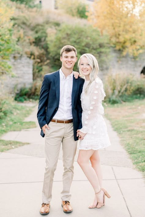 Young couple in formal outfit at fall engagement photo session Groom Engagement Party Outfit, Purple Dress Couple Outfit, Engagement Pictures Mens Outfit, Classic Engagement Photos Outfits, Dressy Engagement Outfits, Engagement Photos Outfits Elegant, Neutral Engagement Outfits Fall, Male Engagement Outfits, Engagement Photos Mens Outfits