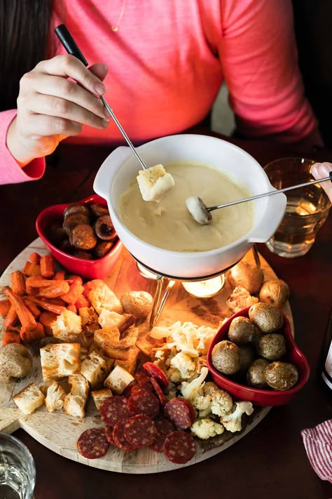 Cheese Fondue for Two: a classic cheese fondue recipe, scaled to the perfect portion to share with your sweetie for a fun & romantic date night at home! 3types of cheese slowly melt into a garlicky white wine sauce, creating an irresistibly rich & creamy fondue. Pair with your favorite dippers – roasted vegetables, sausage, bread, salami, & more! – this homemade fondue is an easy-yet-special recipe for Valentine's Day or your next cozy date night in! #fonduerecipes #fondueideas #datenightideas