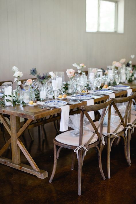 Eclectic head table with candles, bud vases with assorted flowers, and beautiful blue & white china. It makes this wedding reception feel casual and put together.   Farm Table - Vintage wedding - Mix and match china - Bud vase centerpiece #mckinneyweddingplanner #mckinneywedding #mckinneyweddings #weddingplanner #weddingplanning #weddingdetails  #planner #texasweddingplanner #texaswedding  #txweddings #txwedding #wedding #weddingday #weddinginspiration #engagement #proposal  #realwedding Farm Table Wedding, Bud Vase Centerpiece, Kings Table, Vase Centerpiece, Late Summer Weddings, Rustic Wedding Reception, Table Setting Inspiration, Large Centerpiece, Rental Decorating