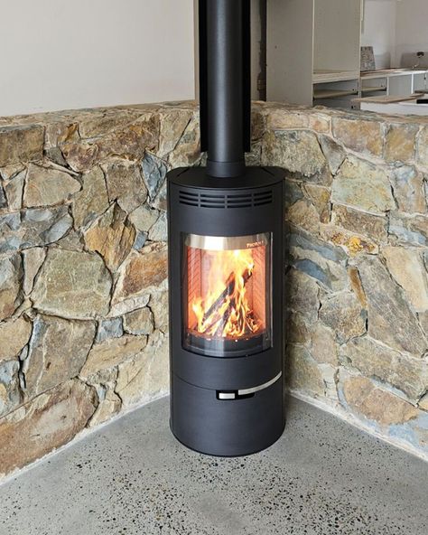 Stunning Andorra installation in Hoddles Creek, Victoria. In this instance the polished concrete floor and stone wall behind the fireplace act as heat proofing, enabling the fireplace to be installed closer to the wall.   #freestandingfire #fireplacedesign #homeinteriors #sustainableheating #woodfire #woodfireplace #woodheater #australianhome Polished Concrete Floor, Standing Fireplace, Wood Heater, Art Studio Design, Freestanding Fireplace, Art Studio At Home, Stone Cladding, Concrete Floor, Wood Fireplace