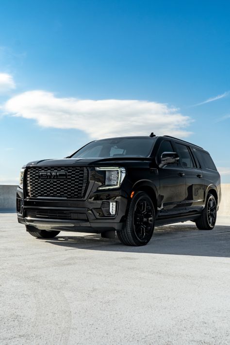 Custom Blackout 2023 GMC Yukon Denali full vehicle view with a cloudy blue sky in the background. 2024 Yukon Denali, Gmc Denali Yukon, 2023 Gmc Yukon Denali, Yukon Denali Ultimate, 2023 Gmc Yukon, Mom Mobile, Gmc Denali, Gmc Yukon Denali, Yukon Denali