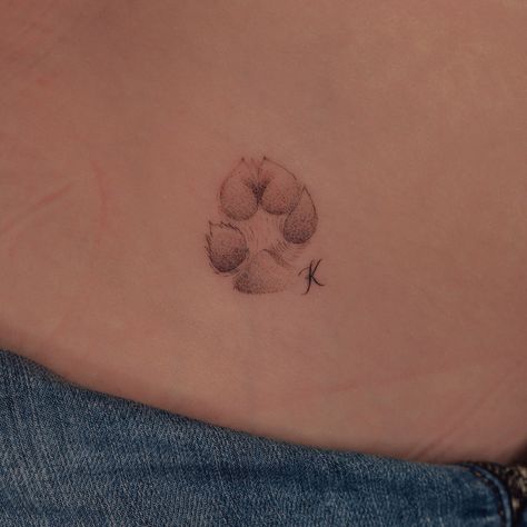 Fineline Dog Paw Tattoo, Red Paw Print Tattoo, Dog Paw Tattoo With Letter, White Paw Print Tattoo, Small Dog Paw Print Tattoo Ideas, Pug Paw Tattoo, Small Dog Tattoo Paw Prints, Dainty Paw Print Tattoo, Dog Tattoo Paw