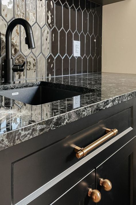 The black cabinets in this custom kitchen are contrasted by the beautiful gold accent finishes and shiny black backsplash Black And Gold Backsplash, Gold Backsplash, Black And Gold Kitchen, Basement Bar Plans, Black Backsplash, Bar Plans, Kitchen Finishes, First Meeting, Gold Kitchen