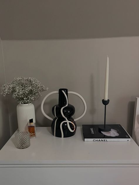 Dresser decorated with vase, flowers, book, candle, and perfume Black Book, Dresser Decor, Black Books, Dresser, Bedroom, Black, Design